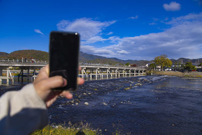Cropped hand of woman using mobile phone