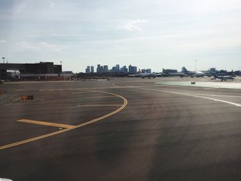 Empty road with buildings in background