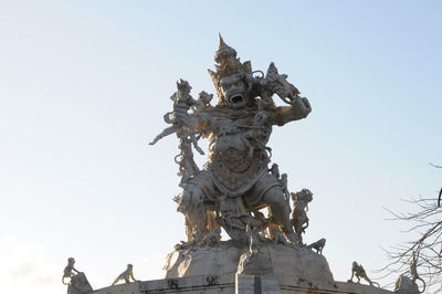 Low angle view of angel statue against clear sky