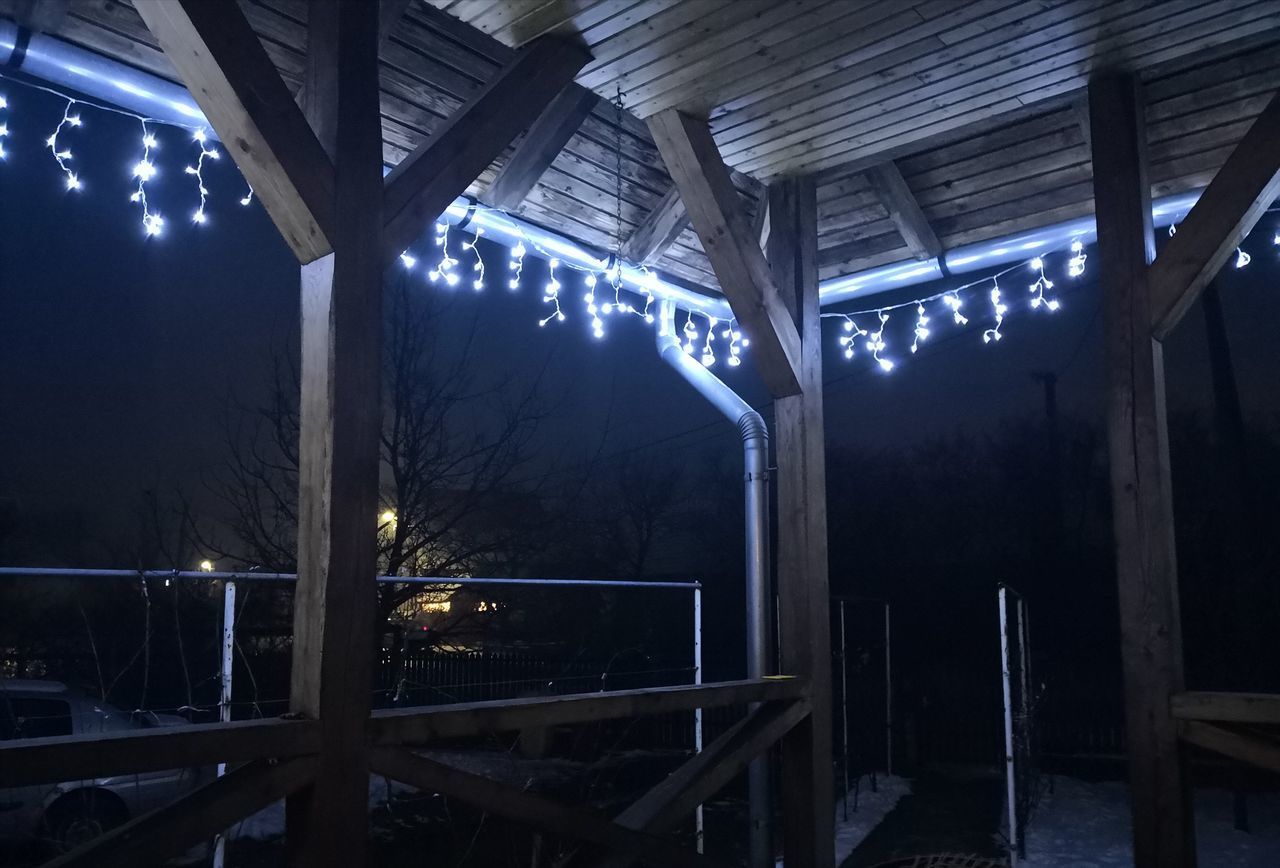 LOW ANGLE VIEW OF ILLUMINATED LIGHTS HANGING ON CEILING