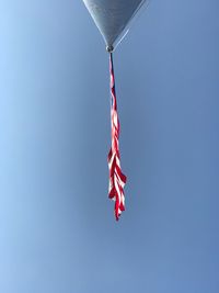 Low angle view of american flag against clear blue sky