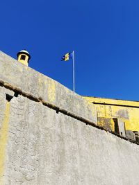 Low angle view of building against blue sky