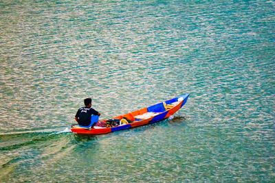 High angle view of men sitting in sea