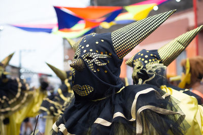 People wearing venetian carnival-style masks are seen during the carnival