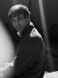 Portrait of young man sitting outdoors