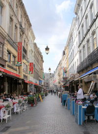 People on street amidst buildings in city