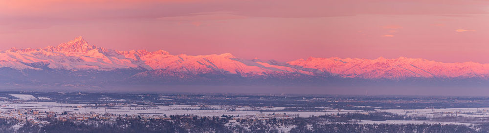 Scenic view of snowcapped mountains against sky during sunset