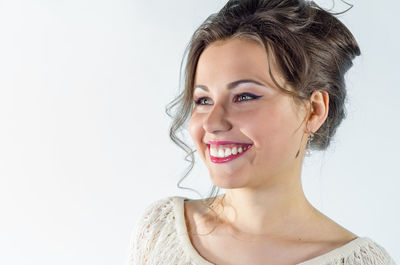 Portrait of a smiling young woman over white background