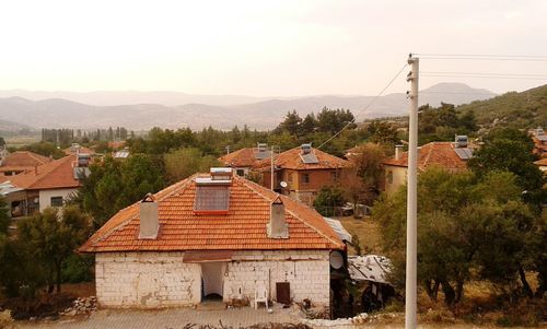 Houses on mountain against clear sky