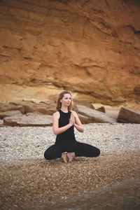 Woman sitting on rock