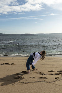 Woman cartwheeling in kimono on the beach