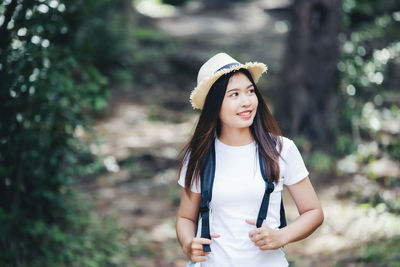Young woman wearing hat standing outdoors