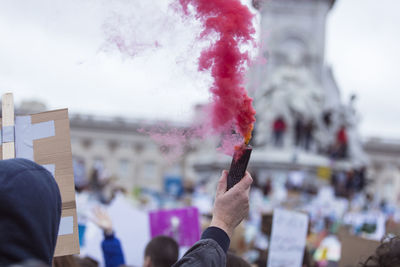 Cropped hand of man holding distress flare