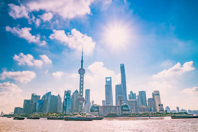 Modern buildings in city against cloudy sky