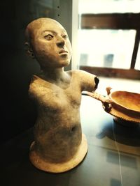 Close-up of statue on table at home