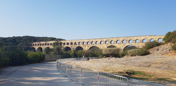 Arch bridge against clear blue sky