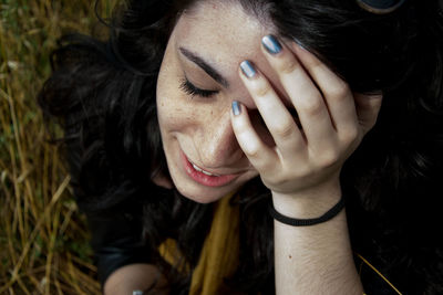 Close-up of sad woman on field