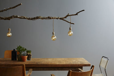 Illuminated light bulbs hanging on table