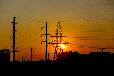 Sunset scene with shadow of electricity poles and houses