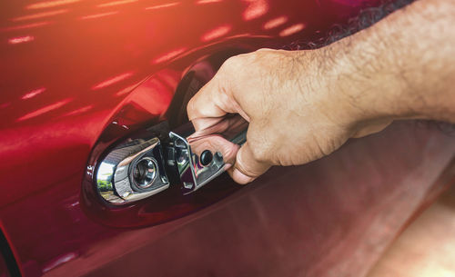 Close-up of man photographing car