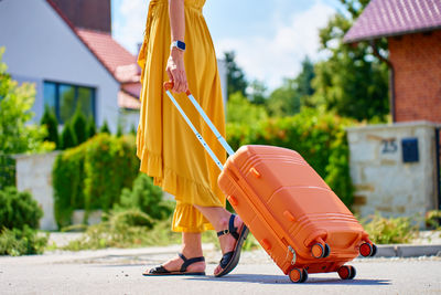 Low section of woman walking on street