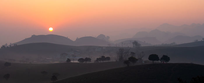 Scenic view of silhouette mountains against sky during sunset