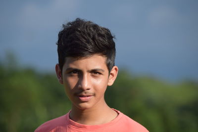 Close-up portrait of boy against clear sky