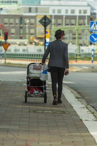 Stylish man strolling baby stroller