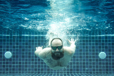 Portrait of man swimming in pool