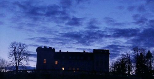 Low angle view of building against cloudy sky