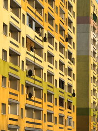 Low angle view of yellow building in city lodz