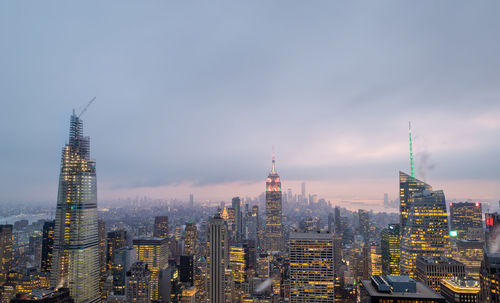 New york skyline from the top of the rock in rockefeller center at night with clouds in the sky