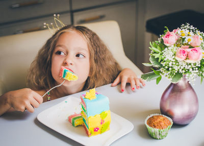 Close-up portrait of girl eating flowers