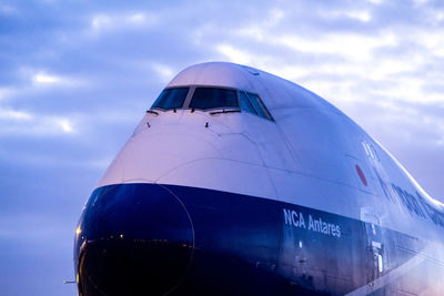 Low angle view of airplane flying against sky