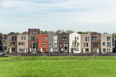 Row of ten houses with varying colors and details to suggest individuality