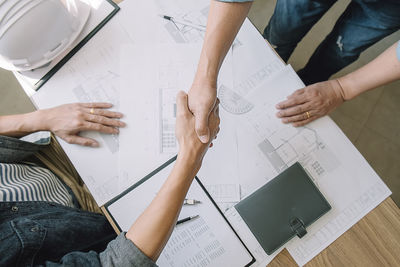 High angle view of people working on table