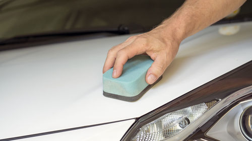 Close-up of hand holding car