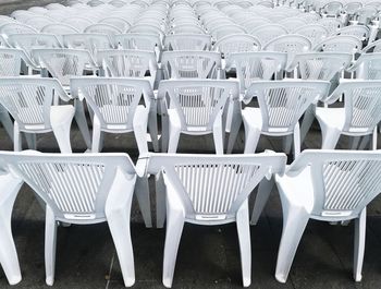 Empty chairs arranged in row at stadium