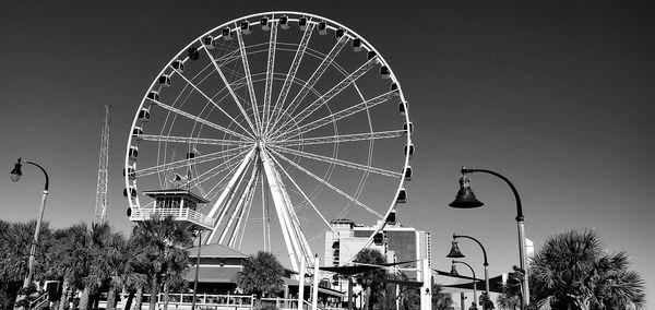Low angle view of ferris wheel against sky