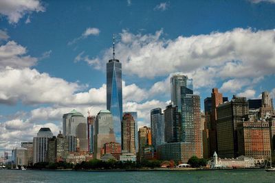 View of skyscrapers against cloudy sky