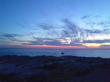 Scenic view of sea against sky at sunset