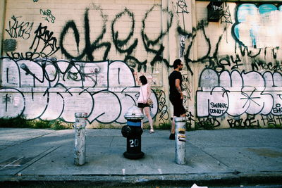 People standing on graffiti wall