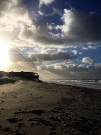 Scenic view of beach against sky during sunset