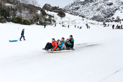 People skiing on snowcapped mountain