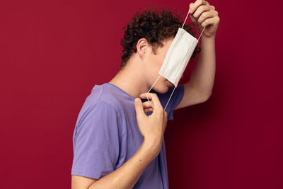 Midsection of woman holding knife against yellow background