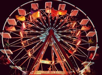 Low angle view of ferris wheel against sky at night