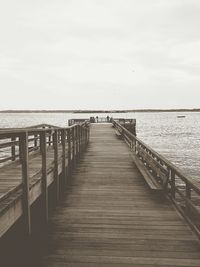 Pier over sea against sky