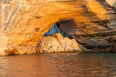 Collapsed rocks covered in birds in a natural arch along pictured rocks national lakeshore