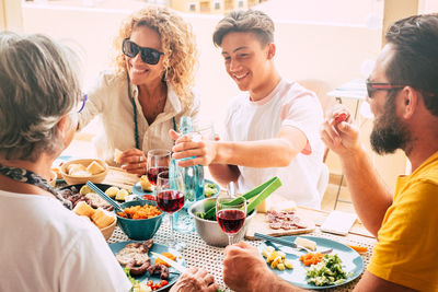 Cheerful family having food on table