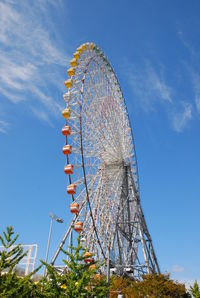 Low angle view of ferris wheel against sky